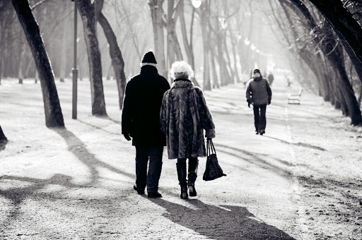 two seniors walking in winter time