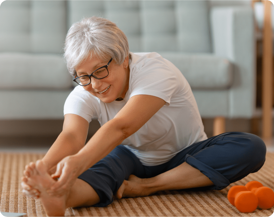 senior-woman-exercising-at-home-2RU8WLB 1